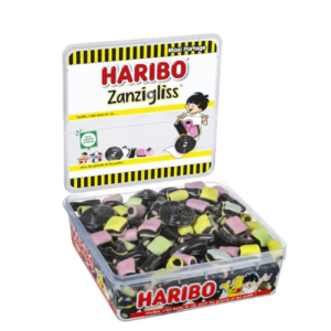 Une boîte en plastique de 1 kg de HARIBO WORLD MIX, remplie de réglisse colorée et de bonbons fondants de différentes formes. L'emballage présente des illustrations ludiques et la marque HARIBO.