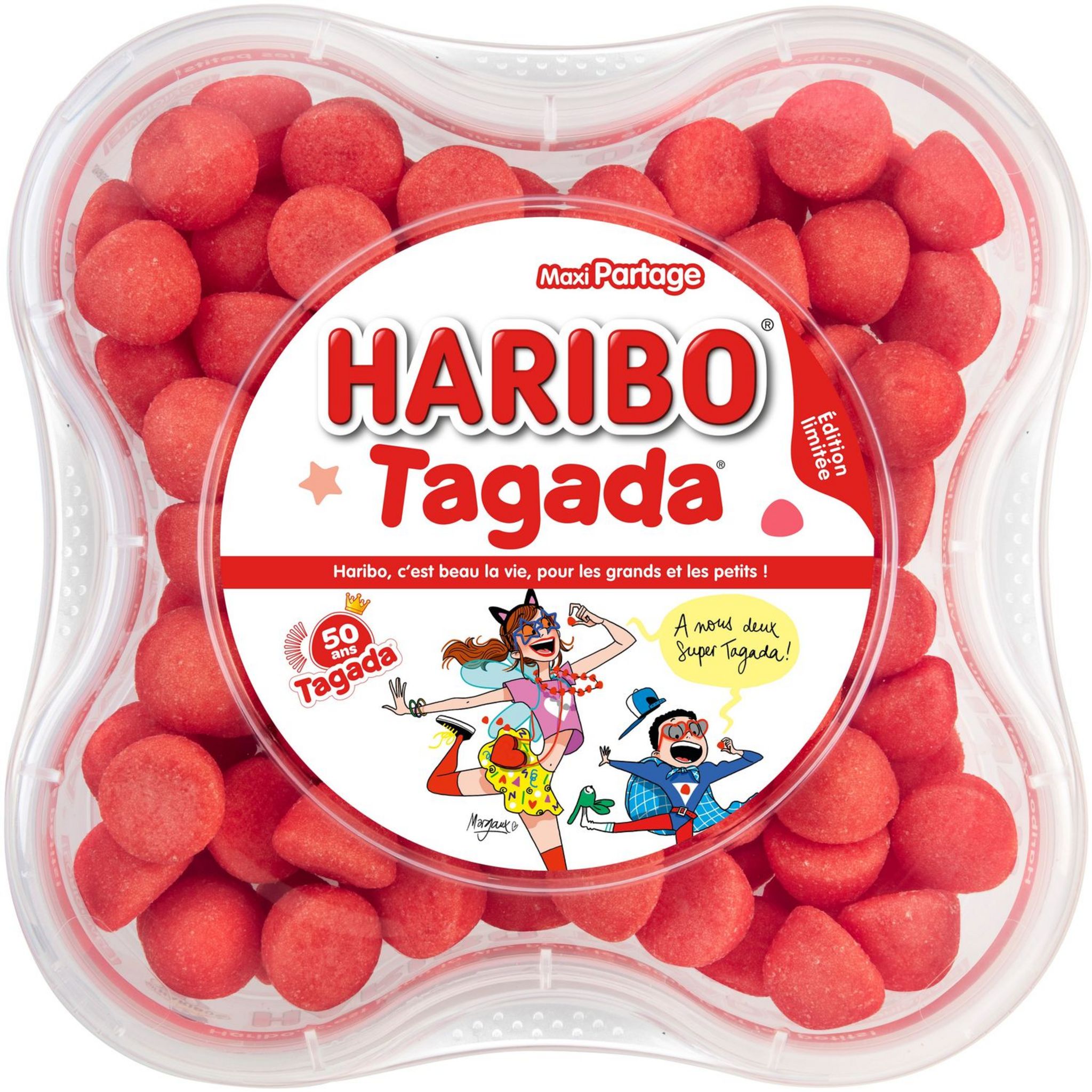Un récipient en plastique transparent contenant des bonbons à la fraise FRAISES TAGADA (1 kg) avec une étiquette colorée comportant des illustrations ludiques, un texte en français et des bonbons ronds rouges visibles à l'intérieur.